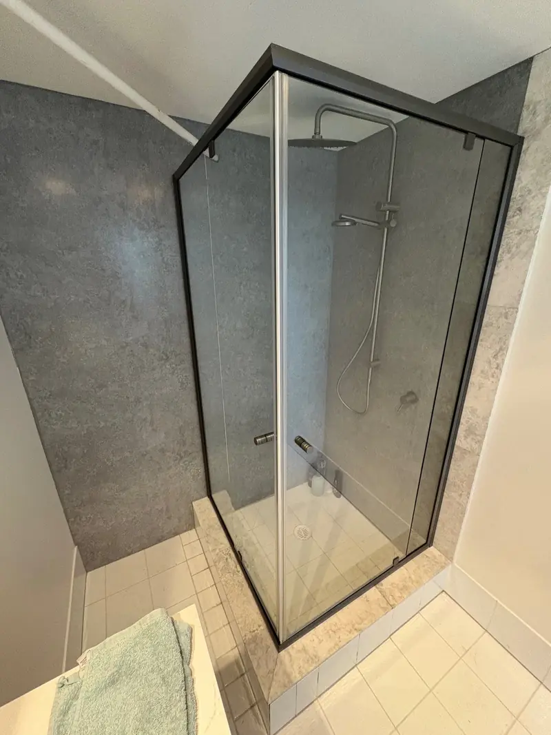 Black semi-frameless corner shower screen