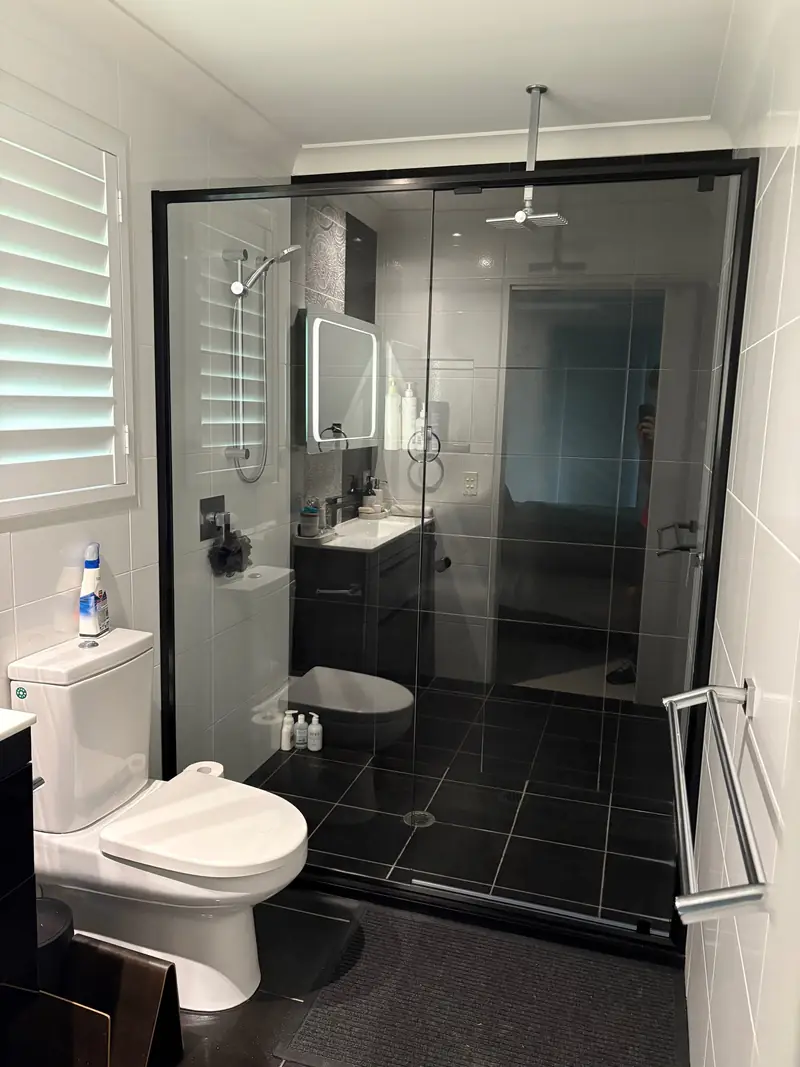 Black semi-frameless shower screen