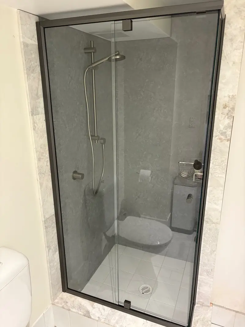 Black semi-frameless shower screen with door