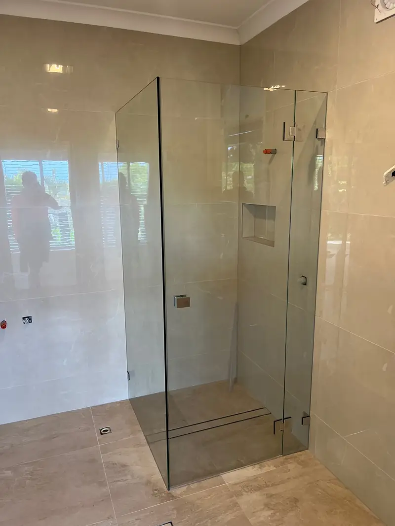 Frameless corner shower enclosure