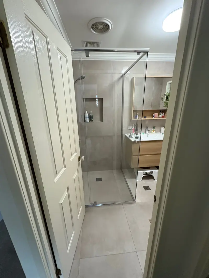 Frameless shower screen in a narrow bathroom