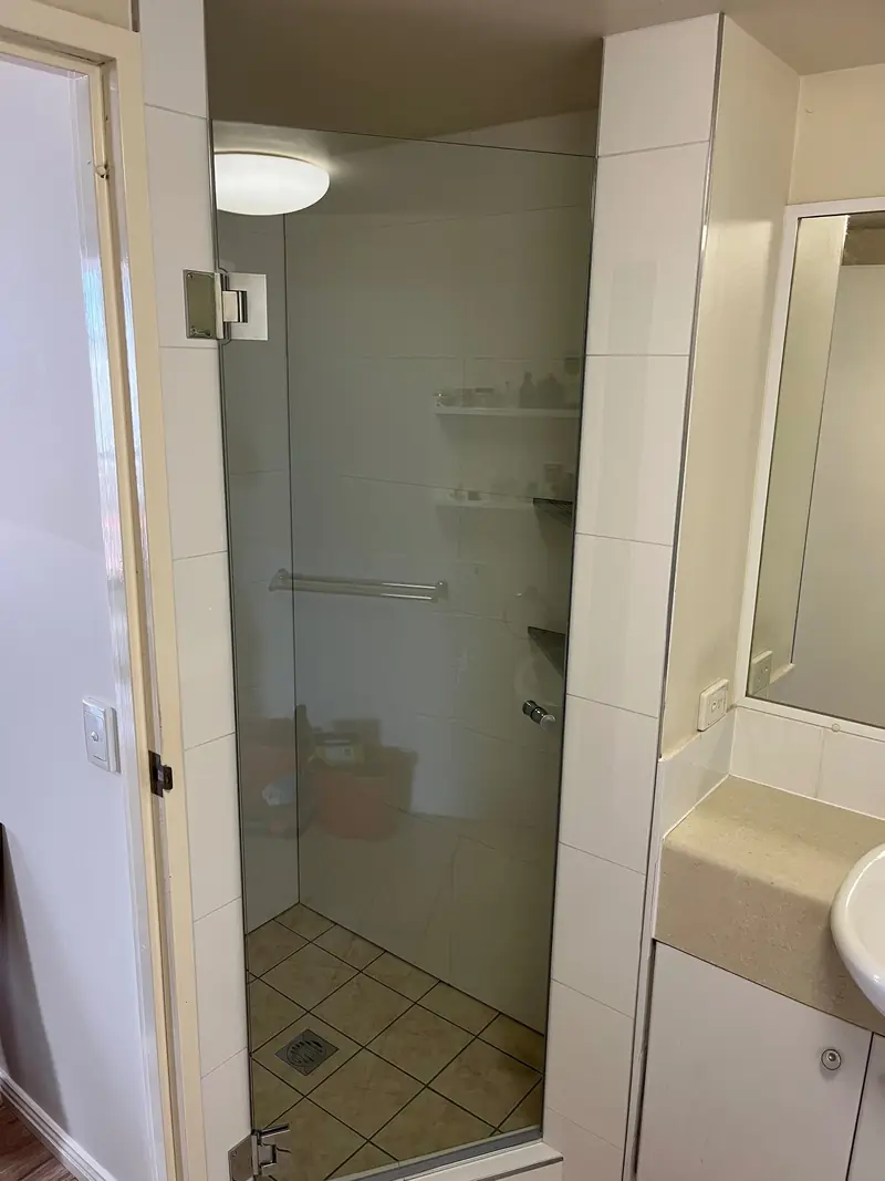 Frameless shower panel and door with chrome hardware