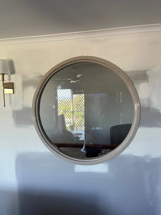 Round framed wall mirror installed by Elder Glass in a Brisbane home