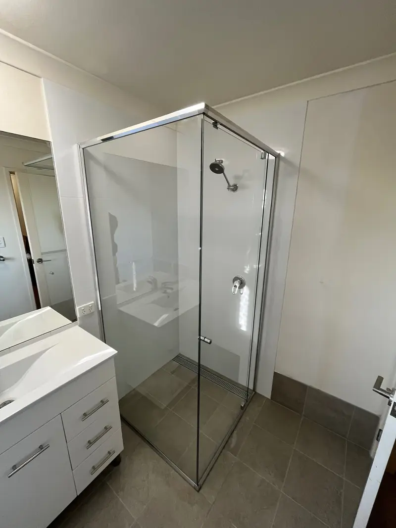 Semi-frameless shower screen in a bathroom with vanity