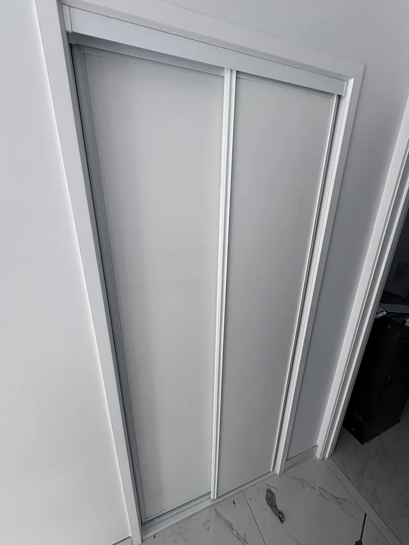 White two-panel sliding wardrobe doors with white aluminium frame, Brisbane